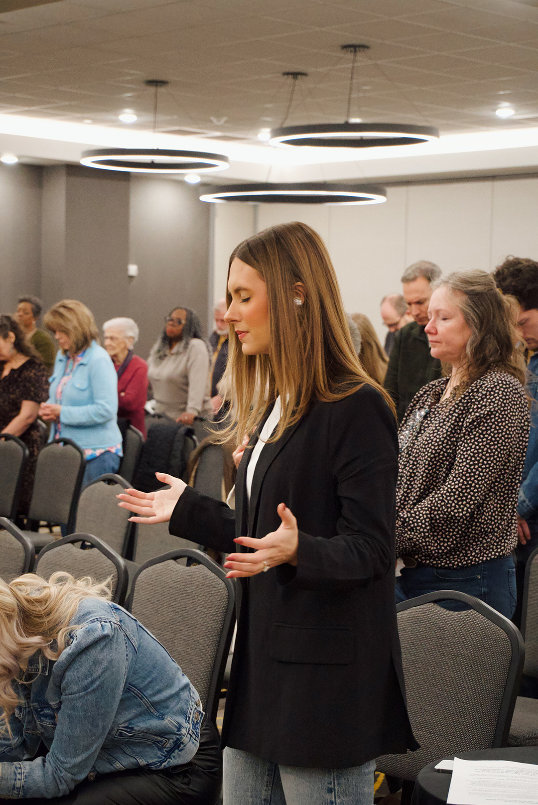 A guest worshipping during a Sunday service at Trinity City Church